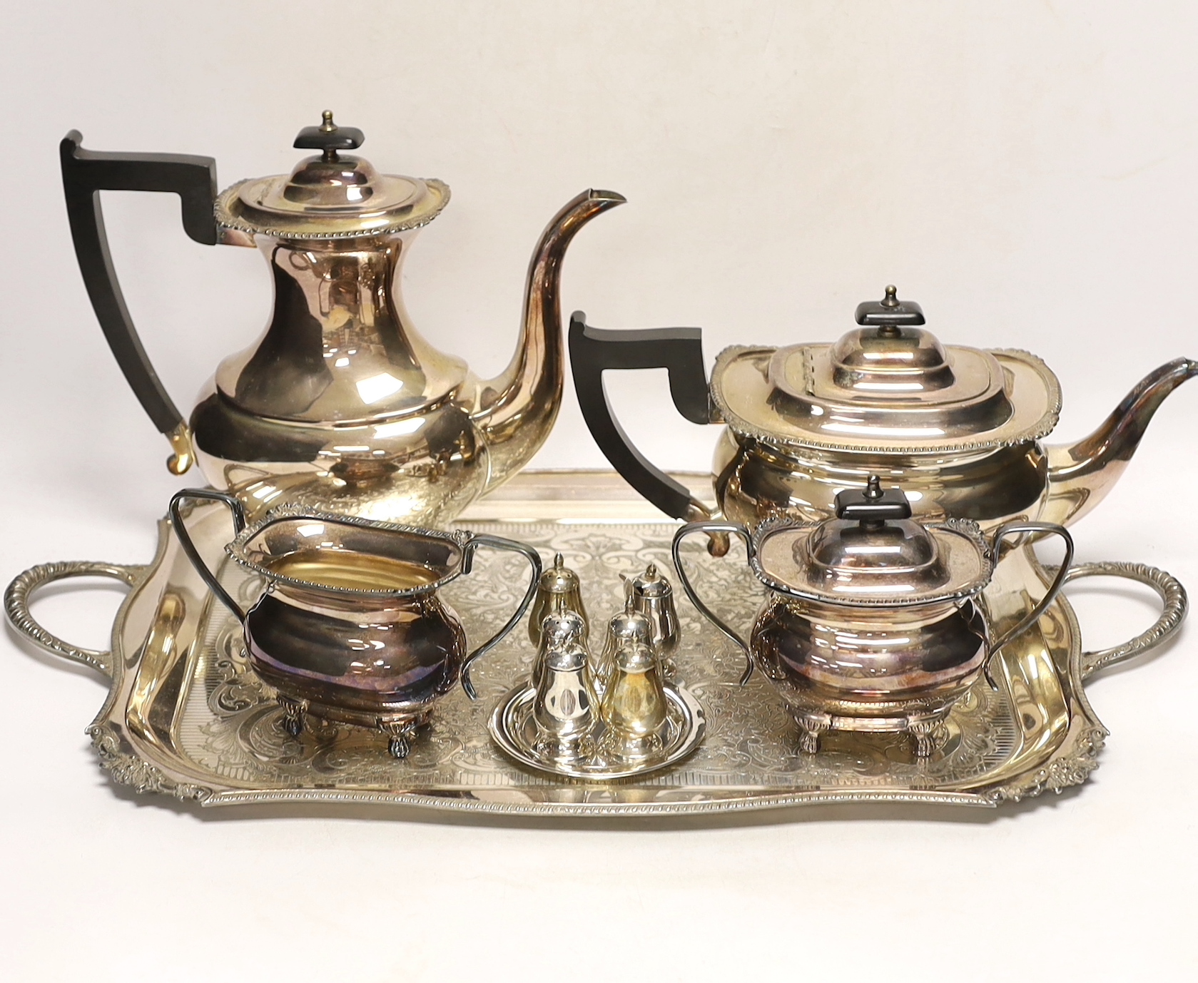 A plated tea / coffee set with ebonised handles and two Sterling condiment sets